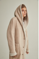 Women's long sheepskin coat of beige color made of natural sheepskin