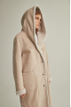 Women's long sheepskin coat of beige color made of natural sheepskin