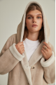 Women's long sheepskin coat of beige color made of natural sheepskin