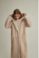 Women's long sheepskin coat of beige color made of natural sheepskin