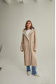 Women's long sheepskin coat of beige color made of natural sheepskin