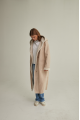 Women's long sheepskin coat of beige color made of natural sheepskin