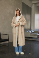 Women's long sheepskin coat of beige color made of natural sheepskin