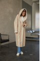 Women's long sheepskin coat of beige color made of natural sheepskin