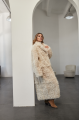 A long two-sided sheepskin coat made of milk-colored natural sheepskin