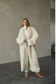 A long two-sided sheepskin coat made of milk-colored natural sheepskin