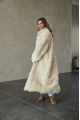 A long two-sided sheepskin coat made of milk-colored natural sheepskin