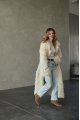 A long two-sided sheepskin coat made of milk-colored natural sheepskin