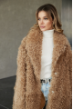 Long two-sided sheepskin coat made of natural sheepskin in camel color