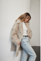 A stylish double-sided sheepskin jacket made of natural white sheepskin