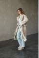 Long two-sided sheepskin coat made of natural sheepskin in beige color