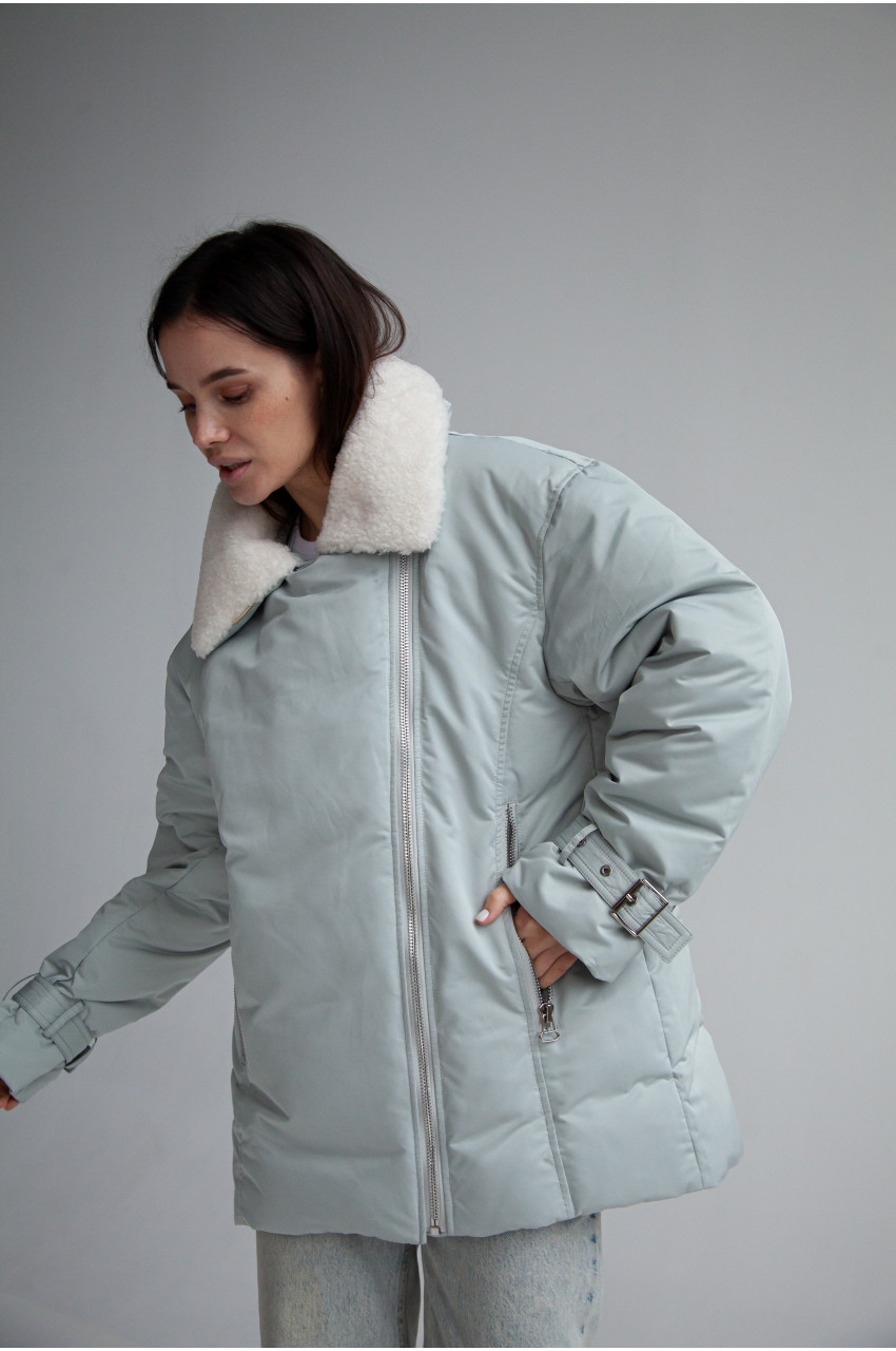 Women's down jacket in a soft mint color with a collar made of sheep fur