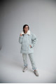 Women's down jacket in a soft mint color with a collar made of sheep fur
