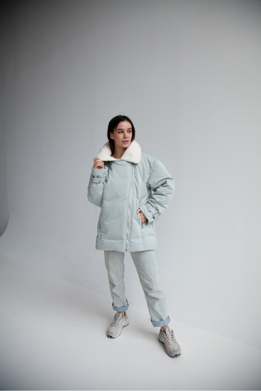 Women's down jacket in a soft mint color with a collar made of sheep fur