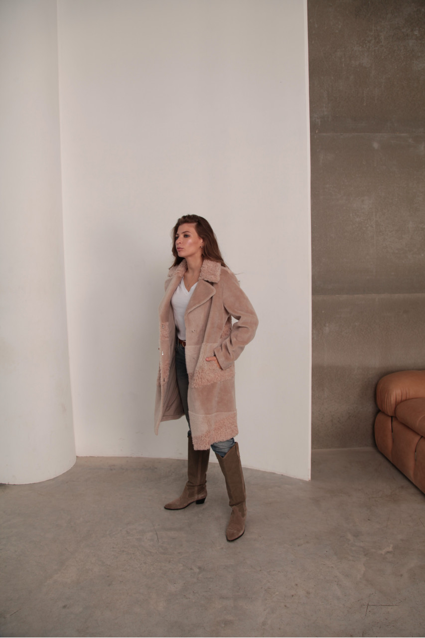 Women's sheepskin coat made of natural wool in a light caramel color
