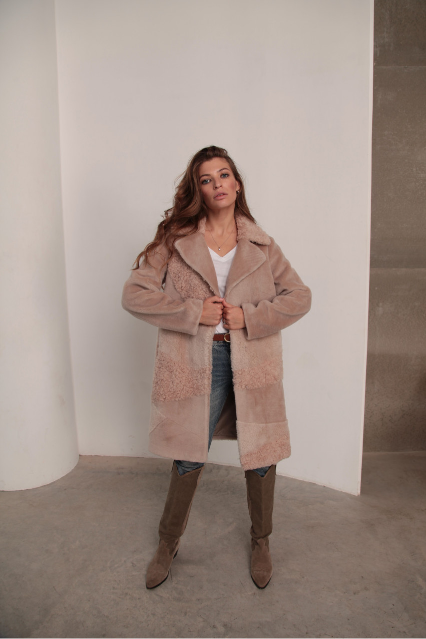 Women's sheepskin coat made of natural wool in a light caramel color
