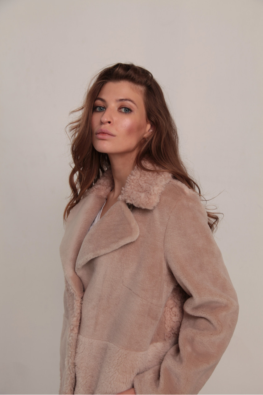 Women's sheepskin coat made of natural wool in a light caramel color